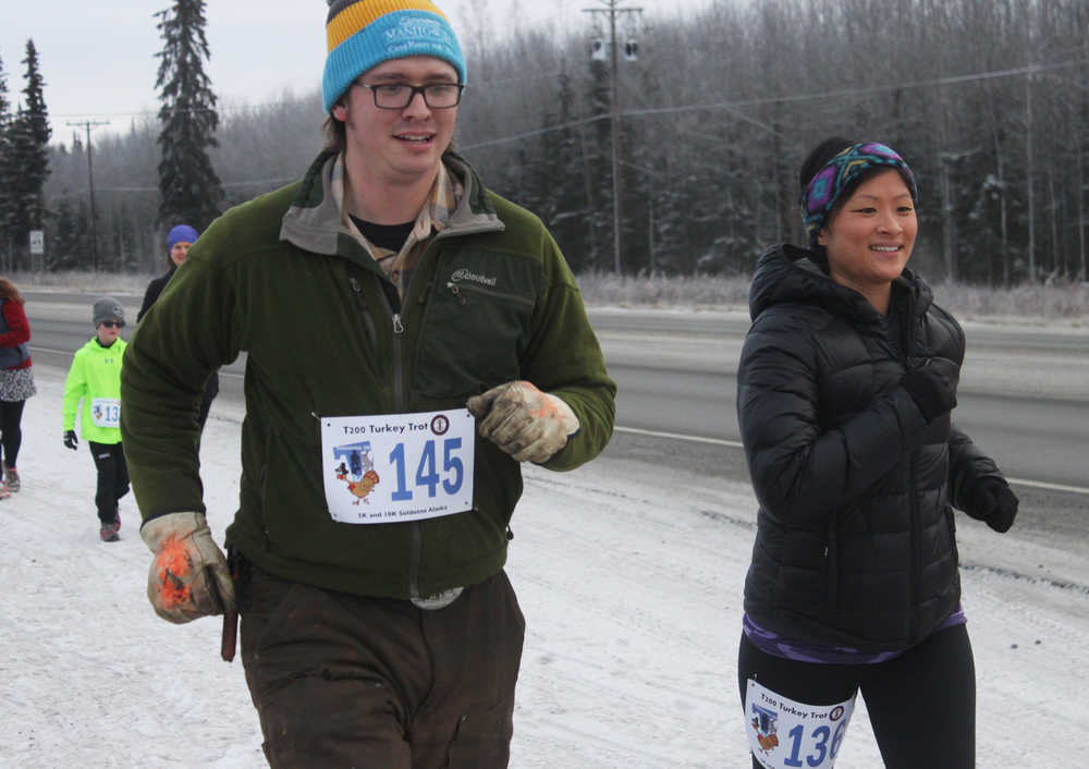 Photo by Kelly Sullivan/ Peninsula Clarion and running the Unity Trail during the T200 Turkey Trot 5k and 10k Run, Friday, Nov. 28, 2014, at the Soldotna Regional Sports Complex in Soldotna, Alaska. Tsalteshi Trails Association teamed up Tustumena 200 Sled Dog Race for this year's fourth annual event.