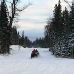 Photo by Dan Balmer/Peninsula Clarion Two Gray Cliffs property owners take off on all-terrain vehicles at the end of the Kenai Spur Highway to access their property Wednesday. The property owners said they cannot get to their land by vehicle because of the rough terrain. Apache Alaska Corporation has proposed a 7.5-mile extension of the Spur Highway to the Gray Cliffs subdivision that would benefit their oil and gas exploration as well as property owners.