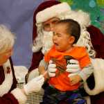 This photo taken Dec. 6, 2014, shows a crying child unsure of what to make of Santa Claus in Shishmaref, Alaska. The Alaska National Guard provided transport for the good Samaritan program Operation Santa, which took gifts and schools supplies to about 300 children in the Inupiat Eskimo community. (AP Photo/Mark Thiessen)