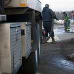 Photo by Rashah McChesney/Peninsula Clarion  A crew works to clean spilled drilling mud from the Kenai Spur Highway on Tuesday Dec. 9, 2014 in Nikiski, Alaska.