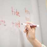 Photo by Rashah McChesney/Peninsula Clarion  Jeanneth Quinche gives a gift to Kathy Christopherson, an English as a Second Language instructor, as the group prepares for the semester's end on Thursday Dec. 11, 2014 in Soldotna, Alaska.