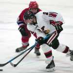 Photo by Rashah McChesney/Peninsula Clarion  Kenai Central High School's Tristan Bulot maneuvers around an East Anchorage High School player during their game Friday Dec. 12, 2014 at the Soldotna Sports Complex in Soldotna, Alaska.