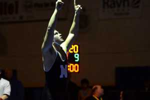 Photo by Joey Klecka/Peninsula Clarion  Nikiski junior Luke Johnson points toward the sky in celebration of his 220-pound state title victory at the Class 1-2-3A state wrestling championships, Saturday at Bartlett High School in Anchorage, Alaska.