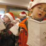 Photo by Kelly Sullivan/ Peninsula Clarion Mountain View Elementary second-grader Alex Collett incorporated some dance moves into his caroling at Charis Place Assisted Living Wednesday, Dec. 17, 2014 in Kenai, Alaska. Collett performed five carols with his classmates.