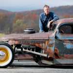 Peter Duvaloois poses with his Rat Rod on Tuesday, Nov. 11, 2014, in Saugerties, N.Y. The fast machines are pieced together from vintage parts and scrapyard finds. They are rumblier, rustier and turn more heads on the highway. (AP Photo/Mike Groll)
