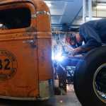 Peter Duvaloois welds a battery box on a Rat Rod at his shop on Tuesday, Nov. 11, 2014, in Saugerties, N.Y. The fast machines are pieced together from vintage parts and scrapyard finds. They are rumblier, rustier and turn more heads on the highway. (AP Photo/Mike Groll)