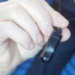 Photo by Kelly Sullivan/ Peninsula Clarion Compassionate Friends of the Kenai Peninsula steering committee member Leslie Boyd wears a vial of her son, Seth Boyd's ashes around her neck Saturday, Dec. 20, 2014 at the Joyce K. Carver Soldotna Public Library in Soldotna, Alaska. Seth Boyd was killed in a plane crash four years ago when he was 29 years old, Leslie Boyd said. "It was very sudden and very traumatic," Leslie Boyd said. "He was my only son, he was an adventurer, poker play, fly fishermen, a lover of beautiful women, many of whom are still my friends."