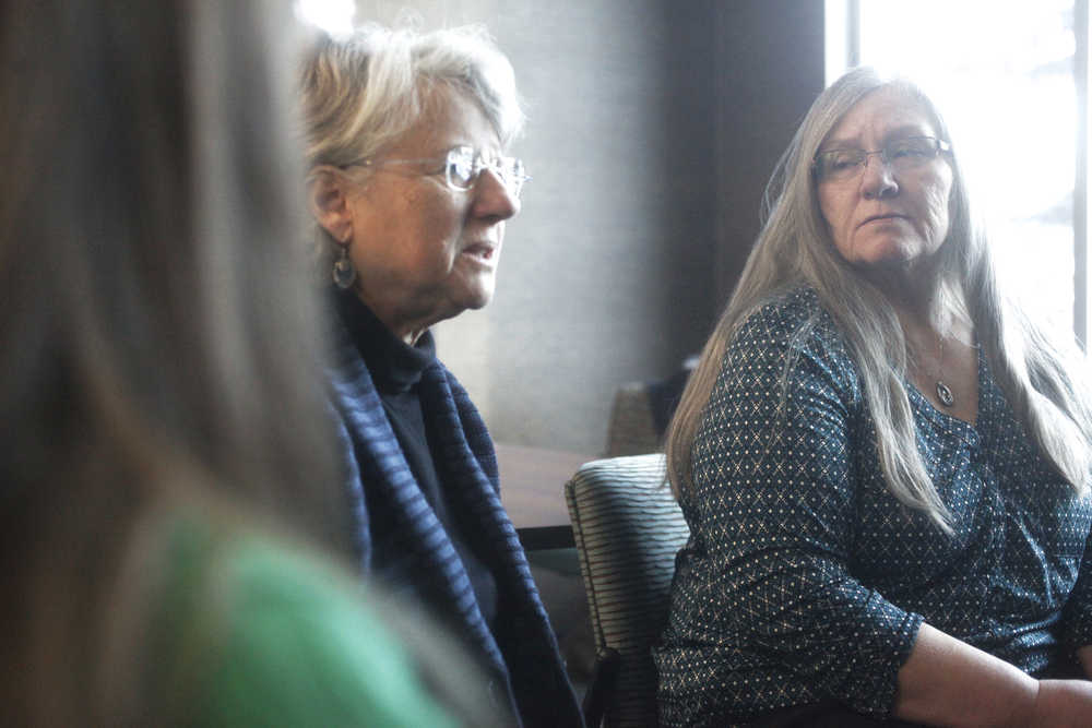 Photo by Kelly Sullivan/ Peninsula Clarion Compassionate Friends of the Kenai Peninsula steering committee member Vickie Herrmann listens to as Leslie Boyd discusses the details of the first candle lighting vigil the group hosted at Christ Lutheran Church Sunday evening on Saturday, Dec. 20, 2014 at the Joyce K. Carver Soldotna Public Library in Soldotna, Alaska. Vickie Herrmann's daughter Jenna Herrmann died in an automobile accident less than three years ago, she said. "Jenna was a sweet soul and she loved children, she loved holidays," Vickie Herrmann said. "Like a lot of young people struggled to find her way, and she is just very deep part of who I am still to this day."