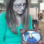 Photo by Kelly Sullivan/ Peninsula Clarion Compassionate Friends of the Kenai Peninsula steering committee members listen to Kit Hill discuss the death of her daughter Amy Hill Saturday, Dec. 20, 2014 at the Joyce K. Carver Soldotna Public Library in Soldotna, Alaska. Amy Hill died from a heart attack 15 years ago, Kit Hill said. "She was a recovering heroin addict and was working at Toys R Us and just loved it," Kit Hill said. "She had moved in with two friends, am so grateful she got that time of joy in her life. I live every day for her for all the things that she wasn't able to do."