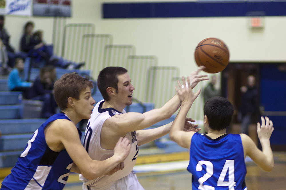 20 looks for an opening during a gameagainst Palmer High School on Friday Dec. 19, 2014 at Soldotna High School in Soldotna, Alaska.