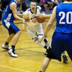 Photo by Rashah McChesney/Peninsula Clarion  Soldotna's 23 runs past Palmer's Jarred Yanez during their game on Friday Dec. 19, 2014 at Soldotna High School in Soldotna, Alaska.