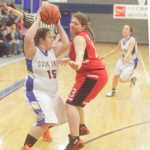 Photo by Kelly Sullivan/ Peninsula Clarion Cook Inlet Academy Eagle's Kendall Taplin tries to pass the ball around Seldovia Lady Sea Otters' Violet Mitchell Saturday, Dec. 20, 2014, at Cook Inlet Academy in Soldotna, Alaska.