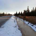 Photo by Dan Balmer/Peninsula Clarion Frozen surface water fills a ditch on Buoy Avenue December 19, 2014. Kenai Peninsula road service crews made ditch improvements to Buoy Avenue, which was built in 2003, this fall after the road saw significant flooding in 2013 because it was not built to borough road standards.