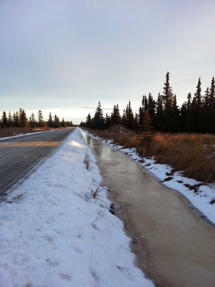 Photo by Dan Balmer/Peninsula Clarion Frozen surface water fills a ditch on Buoy Avenue December 19, 2014. Kenai Peninsula road service crews made ditch improvements to Buoy Avenue, which was built in 2003, this fall after the road saw significant flooding in 2013 because it was not built to borough road standards.