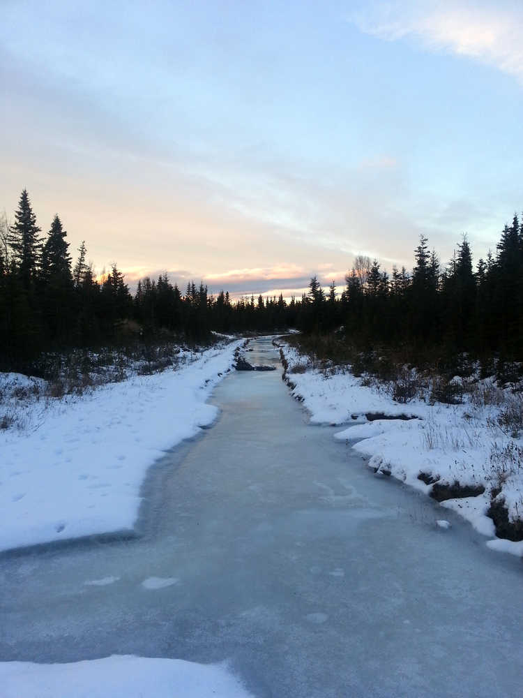 Photo by Dan Balmer/Peninsula Clarion A frozen creek inbetween Eider Drive and Chine Circle off the Kalifornsky Beach Road on Dec. 19, 2014. The Kenai Peninsula Borough installed culverts and cleared out ditches to allow surface water to flow out the Chine outlet after the K-beach flooding impacted area residents homes in 2013.