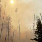 Photo by Rashah McChesney/Peninsula Clarion A Black Hawk helicopter dumps water on a portion of the Funny River Wildfire Monday May 26, 2014 in the Funny River community in Soldotna, Alaska. The wildfire has burned more than 156,000 acres and prompted three evacuations on the Kenai Peninsula.