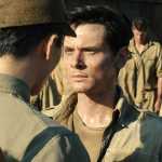 In this image released by Universal Pictures, Jack O'Connell portrays Olympian and war hero Louis "Louie" Zamperini in a scene from "Unbroken." The film, directed by Angelina Jolie, did not receive any Golden Globe nominations on Thursday.  (AP Photo/Universal Pictures)