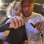 Photo by Rashah McChesney/Peninsula Clarion  Zaydri Pond, 3, helps her dad Shane Pond trim a bit of yarn tied to a fishing hook during a fly-tying class on Tuesday Jan. 6, 2014 at the Main Street Tap & Grill in Kenai, Alaska.