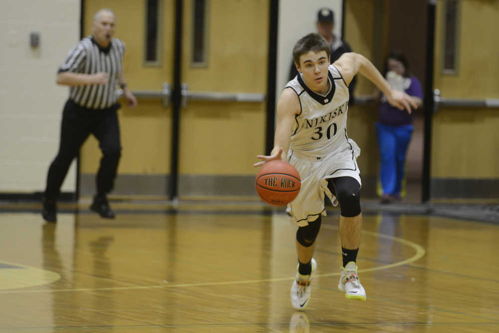 Photo by Rashah McChesney/Peninsula Clarion Nikiski's Sam Tauriained sprints down the court during their game against Homer on Saturday Jan. 10,  2015 at Nikiski Middle-High School in Nikiski, Alaska.