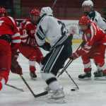 Photo by Kelly Sullivan/ Peninsula Clarion Soldotna High School Stars' Trevor Witthus maintains control of the puck from a group of Wasilla Colony High School Knights, Thursday, January 15, 2015, at the Soldotna Regional Sports Complex in Soldotna, Alaska.