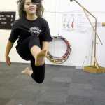 Photo by Rashah McChesney/Peninsula Clarion  Kya Ahlers, 13, grins after realizing that she had hit a bag that was lifted 70-inches off the ground as she practiced for the Native Youth Olympics on Wednesday Jan. 14, 2015 at the Yaghanen Youth Center in Soldotna, Alaska. Ahlers had been practicing for several minutes when Kenaitze Indian Tribe Yaghanen programs director Michael Bernard lifted the bag as she looked away. She said it was the highest she'd ever managed to kick the bag.