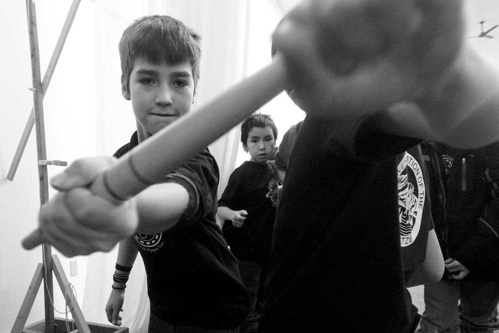 Photo by Rashah McChesney/Peninsula Clarion  Kya Ahlers, 13, practices her one-foot high kick for the Native Youth Olympics on Wednesday Jan. 14, 2015 at the Yaghanen Youth Center in Soldotna, Alaska. Ahlers had been practicing for several minutes when Kenaitze Indian Tribe Yaghanen programs director Michael Bernard lifted the bag to 70-inches as she looked away. She said it was the highest she'd ever managed to kick the bag.