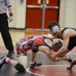 Photo by Kelly Sullivan/ Peninsula Clarion Kenai Central High School Kardinal Ellery Steffensen tackels Soldotna High School Star xxx from below during the 160 weight-class match, Thursday, Jan. 22, 2015, at Kenai Central High School in Kenai, Alaska.