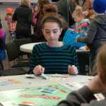 Ben Boettger/Peninsula Clarion Leah English considers a move at the Winter Games Monopoly tournament at the Soldotna Sports Complex on Saturday, Jan. 24.