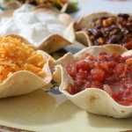 To keep baked tortilla shells from becoming soggy, fill with chili toppings, such as salsa, cheese and sour cream, just before serving.