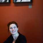 Photo by Rashah McChesney/Peninsula Clarion Kaitlin Vadla looks at her paintings while talking to a reporter on Wednesday Jan. 28, 2015 at The Flats Bistro in Kenai, Alaska.