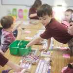 Photo by Kelly Sullivan/ Peninsula Clarion Nate Hadfield reaches for a pair of 'googgley eyes' to glue onto his valentine's caterpillar he is making for class Friday, Jan. 30, 2015, at The Study in Soldotna, Alaska.