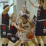 Kenai's Allie Ostrander fights for a ball with Juneau-Douglas' Rachelle Roldan as the Kardinals' Sarah Every and Alexis Baker (22) and Crimson Bears Cassie Dzinich look on during the Kardinals' 34-16 win over the Crimson Bears on Thursday in Juneau.