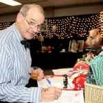 Oiler fan Bob Bird bids on silent auction items