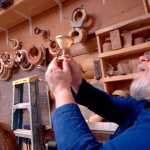 Ben Boettger/Peninsula Clarion Lee Halstead (right) examines the thin, translucent cup of a birch goblet carved by Sterling Rasmussen (left) at a Kenai Peninsula Woodturner's meeting at the "3 Guys, No Wood" workshop on Saturday, Feb. 14.