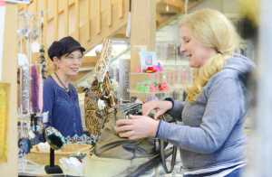 Photo by Kelly Sullivan/ Peninsula Clarion Elizabeth Ward, who owns 'Bead It' with her husband Jimmy Ward, chats with Amiel Severson Monday, Feb. 16, 2015, in Soldotna Alaska. Severson said she comes consistently but refers to herself as an "irregular" customer.