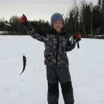 Noah Payne shows off his catch during Ice Fishapalooza Sunday on Sport Lake in Soldotna. (Photo by Dave Atcheson)