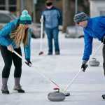 ADVANCE FOR USE MONDAY, FEB. 16 - In this photo taken Jan. 17, 2015, curling enthusiasts sweep the ice behind a stone during a curling clinic hosted by the Bozeman Parks and Recreation Department at Southside Park in Bozeman, Mont.. Participants learn the basics of the game and help raise interest in the sport. (AP Photo/Bozeman Daily Chronicle, Adrian Sanchez-Gonzalez)