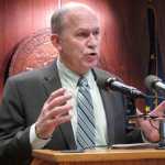 Gov. Bill Walker speaks with reporters during a news conference on his plans to seek dismissal of a lawsuit he brought before taking office involving the Point Thomson oil and gas field, on Wednesday, Feb. 11, 2015, in Juneau, Alaska. (AP Photo/Becky Bohrer)