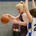 Photo by Kelly Sullivan/ Peninsula Clarion Nikolaevsk Warrior Nadejda Gordeev dribbles the ball around Cook Inlet Academy Eagle Danielle Hills Thursday at Cook Inlet Academy in Soldotna.