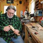 Dennis Bertram, 62, carves out a fish decoy in his workshop Tuesday, Feb. 24, 2015, in Belgrade, Minn. Bertram has been carving decoys for 35 years and spearing for 40, creating decoys from two inches long to almost 40 inches long. (AP Photo/St. Cloud Times, Jason Wachter) NO SALES