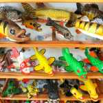 Handmade fish decoys are displayed Tuesday, Feb. 24, 2015, in Belgrade, Minn. Dennis Bertram uses glass eyes for his decoys and has been carving them for 35 years. (AP Photo/St. Cloud Times, Jason Wachter) NO SALES