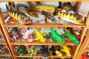 Handmade fish decoys are displayed Tuesday, Feb. 24, 2015, in Belgrade, Minn. Dennis Bertram uses glass eyes for his decoys and has been carving them for 35 years. (AP Photo/St. Cloud Times, Jason Wachter) NO SALES