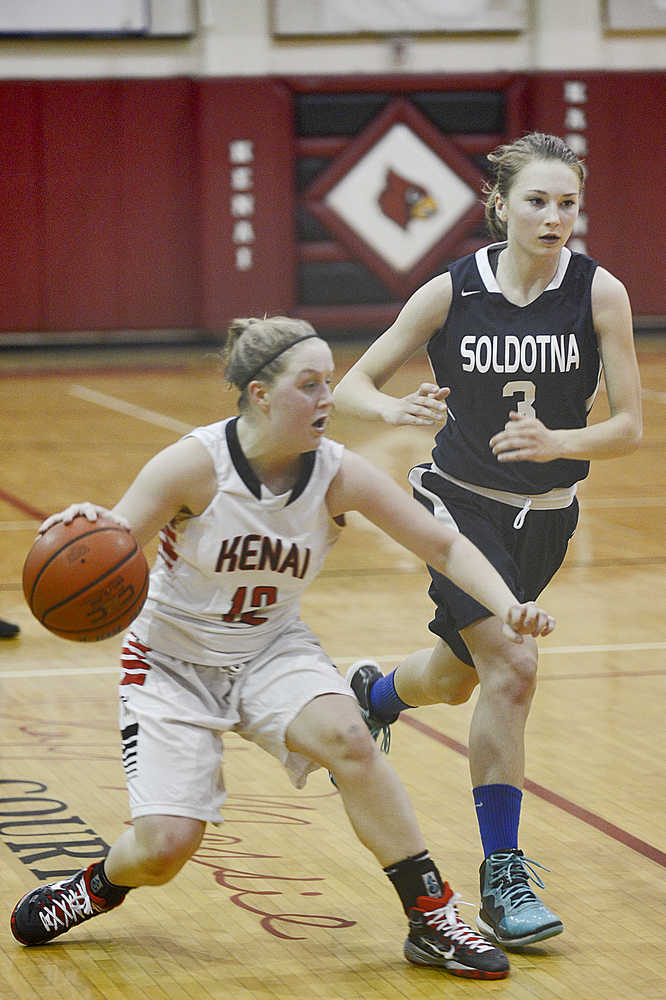 Photo by Rashah McChesney/Peninsula Clarion  Kenai's Allie Ostrander takes off after Soldotna's Lindsey Wong during their game for the Northern Lights Basketball Tournament on Thursday March 5, 2015 in Kenai, Alaska.