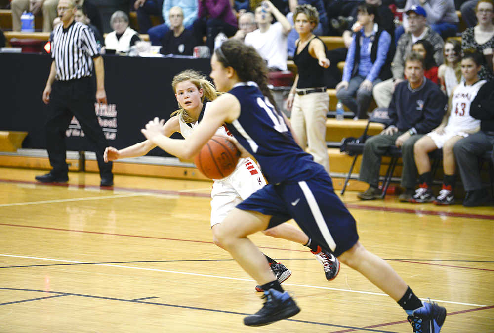 Photo by Rashah McChesney/Peninsula Clarion  Kenai's Marshall Vest looks for an opening to pass during their game against Soldotna at the Northern Lights Basketball Tournament on Thursday March 5, 2015 in Kenai, Alaska.