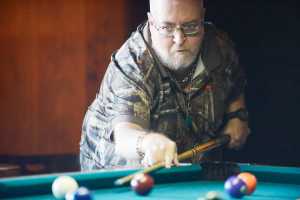 Photo by Kelly Sullivan/ Peninsula Clarion Gary Dixon lines up his shot during the 9-Ball memorial tournament for Mike Exum and John "Griz" Young Sunday, March 8, 2015, at the Alaska Roadhouse Bar and Grill in Soldotna, Alaska.
