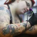 Photo by Kelly Sullivan/ Peninsula Clarion Sam Hayes works has been working for Ink Works since just after it opened three years ago. She said her favorite client was 79 before she received her first tattoo, and had five drawn on her before she passed away Saturday, March 14, 2015, at Ink Works in Kenai, Alaska.