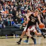 Photo by Rashah McChesney/Peninsula Clarion Nikolaevsk's Neil Gordeev tries to stop before shooting during his team's game against Noorvik on March 14, 2015 in Anchorage, Alaska. Nikolaevsk won 50-33.