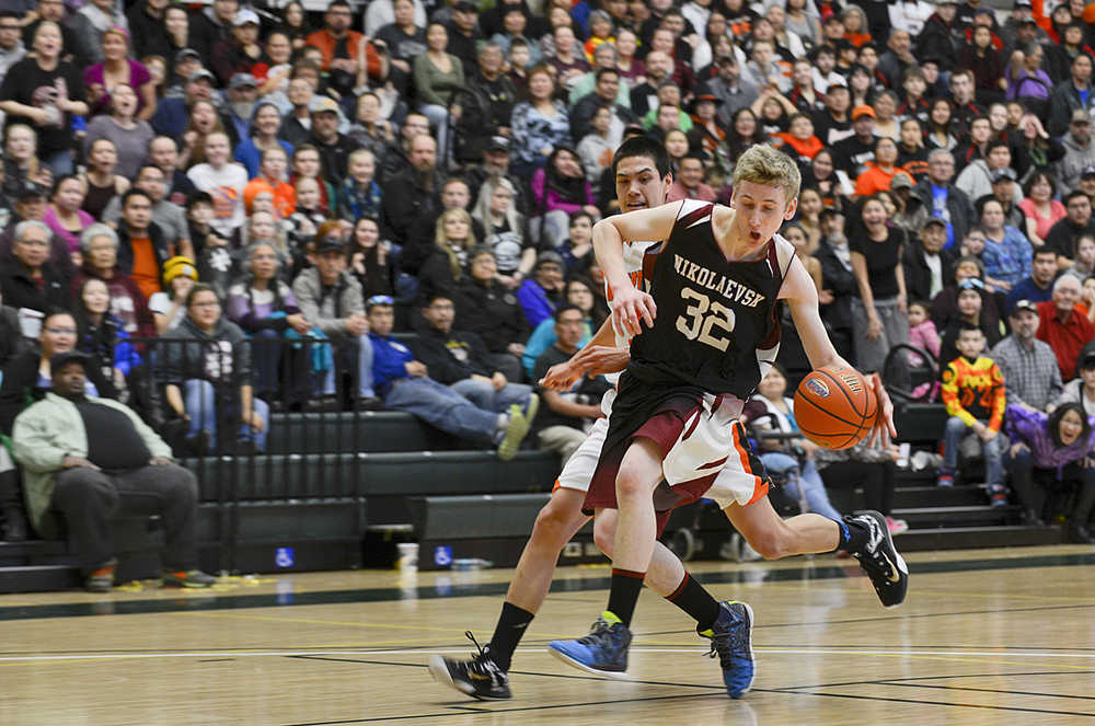 Photo by Rashah McChesney/Peninsula Clarion Nikolaevsk's Neil Gordeev tries to stop before shooting during his team's game against Noorvik on March 14, 2015 in Anchorage, Alaska. Nikolaevsk won 50-33.