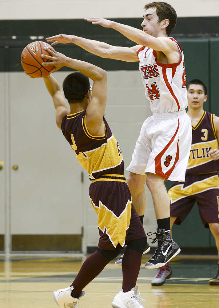 Photo by Rashah McChesney/Peninsula Clarion  Seldovia's Calem Collier jumps to block a pass during their game against Kotlik for the 2015 March Madness Small School Tournament in Anchorage, Alaska.