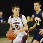 Photo by Rashah McChesney/Peninsula Clarion  Nikolaevsk's Nikit Fefelov darts around Angoon's Duncan O'Brien during their game on March 16, 2015 for the March Madness Small Schools state championships in Anchorage, Alaska.